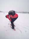 Snowshoe hiking in land. Active outdoor man hikes in farm range Royalty Free Stock Photo