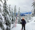 A snowshoer walking and admiring the stunning beauty of the winter landscape on Cypress Mountain