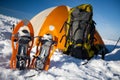 Snowshoes left in front of orange tent in winter forest