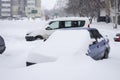 A snowstorm in the city. Cars covered with snow Royalty Free Stock Photo