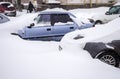 A snowstorm in the city. Cars on the streets in snowdrifts Royalty Free Stock Photo