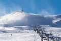 Snow flurries over the ski lifts in the winter sports area of the Sierra Nevada. Royalty Free Stock Photo