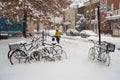 Snowstorm in Montreal. Bikes covered in snow.