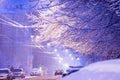 Snowstorm, snow-covered street and cars during the snowfall in t