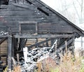 Snowy abandoned burned-out fire wooden black house. Royalty Free Stock Photo