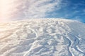 Snowy abstract off-piste skiing backround with ski and snowboard trails and tracks on new virgin powder snow and blue Royalty Free Stock Photo