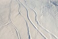 Snowy abstract off-piste skiing backround with ski and snowboard trails and tracks on new virgin powder snow. morning Royalty Free Stock Photo