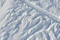 Snowy abstract off-piste skiing backround with ski and snowboard trails and tracks on new virgin powder snow. morning sunrise or Royalty Free Stock Photo