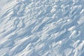 Snowy abstract off-piste skiing backround with ski and snowboard trails and tracks on new virgin powder snow. morning sunrise or Royalty Free Stock Photo