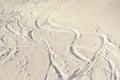 Snowy abstract off-piste skiing backround with ski and snowboard trails and tracks on new virgin powder snow. morning sunrise or Royalty Free Stock Photo