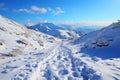 Snowy ascent Human footprints mark hillside climb in tranquil winter landscape