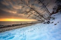 Snowy beach in Gdynia Orlowo at sunrise, Baltic Sea. Poland