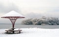 Snowy beach with lonely umbrella