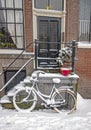 Snowy bike in front of a traditional house in Amsterdam the Netherlands Royalty Free Stock Photo