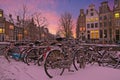 Snowy bikes in Amsterdam the Netherlands at sunset Royalty Free Stock Photo