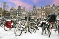 Snowy bikes in Amsterdam the Netherlands at sunset