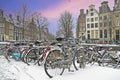 Snowy bikes in Amsterdam the Netherlands at sunset Royalty Free Stock Photo