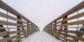 Snowy bridge against frosty landscape and sky