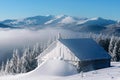 Snowy cabin in the winter mountains