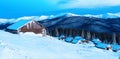 Snowy cabin in the winter mountains