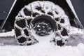 Snowy Chained wheel of a snow plow Royalty Free Stock Photo