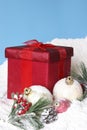 Snowy Christmas Pines Baubles and Gift Box Royalty Free Stock Photo