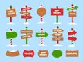 Snowy Christmas wooden signs. Happy winter holidays, Santa_s house, Xmas elf village, toy shop and welcome pointers with snow caps Royalty Free Stock Photo