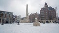 Snowy city Amsterdam at the Dam square in the Netherlands in winter Royalty Free Stock Photo