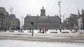 Snowy city Amsterdam at the Dam square in the Netherlands in winter Royalty Free Stock Photo