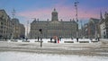 Snowy city Amsterdam at the Dam square in the Netherlands in winter Royalty Free Stock Photo