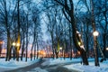 Snowy city park in the light of lanterns at evening in Gomel, Be Royalty Free Stock Photo