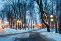 Snowy city park in the light of lanterns at evening in Gomel, Belarus Royalty Free Stock Photo
