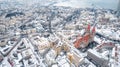a snowy winter city skyline with tall buildings and a red roofed church Royalty Free Stock Photo