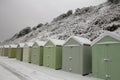 Snowy classic English beach huts Royalty Free Stock Photo