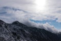Snowy cloud covered mountain peak