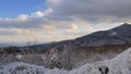 Snowy clouds and sun over the mountains, time lapse