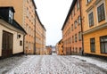 Snowy cobbled street of traditional buildings in Sodermalm, Stockholm, Sweden.