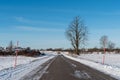 Snowy country road with snow stakes