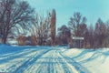 Snowy country road in winter sunny day Royalty Free Stock Photo