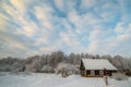 Snowy countryside of little wooden houses near forest
