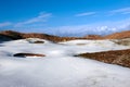 Snowy covered links golf course with yellow flag