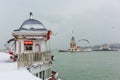 Snowy day in Uskudar with Maiden`s Tower. Istanbul, Turkey