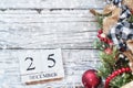 Snowy December 25th Calendar Blocks against White Rustic Background