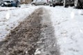 Snowy and difficult roads after snowfall in winter. Muddy tire print in snow, blurry cars in background Royalty Free Stock Photo