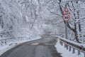 Snowy driveway and road sign speed limit 30 km. Winter forest after snowfall. Bad weather, fall. Royalty Free Stock Photo