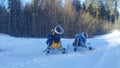 On a snowy edge of the forest near one of the slopes of the ski center there are snow cannons. The weather is frosty and sunny in Royalty Free Stock Photo