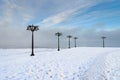 Snowy embankment along the misty river with lanterns at the foggy morning - winter landscape. I