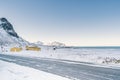 Snowy empty road along the sea & shoreline in the white cold world of north Norwegian islands. Royalty Free Stock Photo