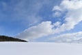 A snowy field under a blue sky