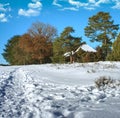 Snowy footpath leading to a historic sheep pen in the heath near Gifhorn, Germany